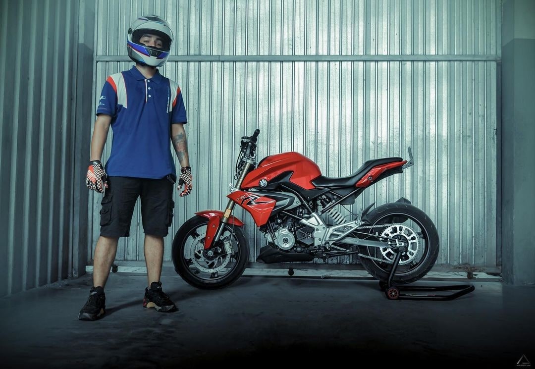 Sparrowteck rider standing beside a performance motorcycle
